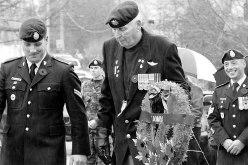 Bill Robison laying a wreath at Remembrance Day in Sydenham in 2014. We don't know what he said to the two officers in the photo, but it sure cracked them up.